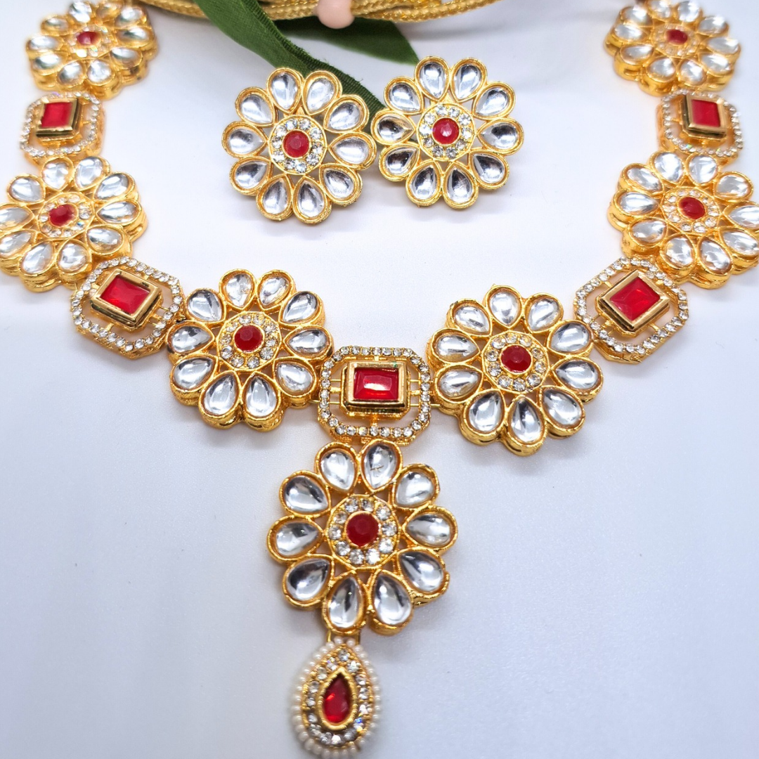 Gold-plated floral necklace set with red and white stones, matching earrings