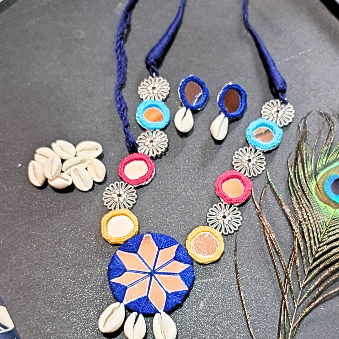 Handcrafted shell and mirror necklace set with colorful threadwork and peacock feather
