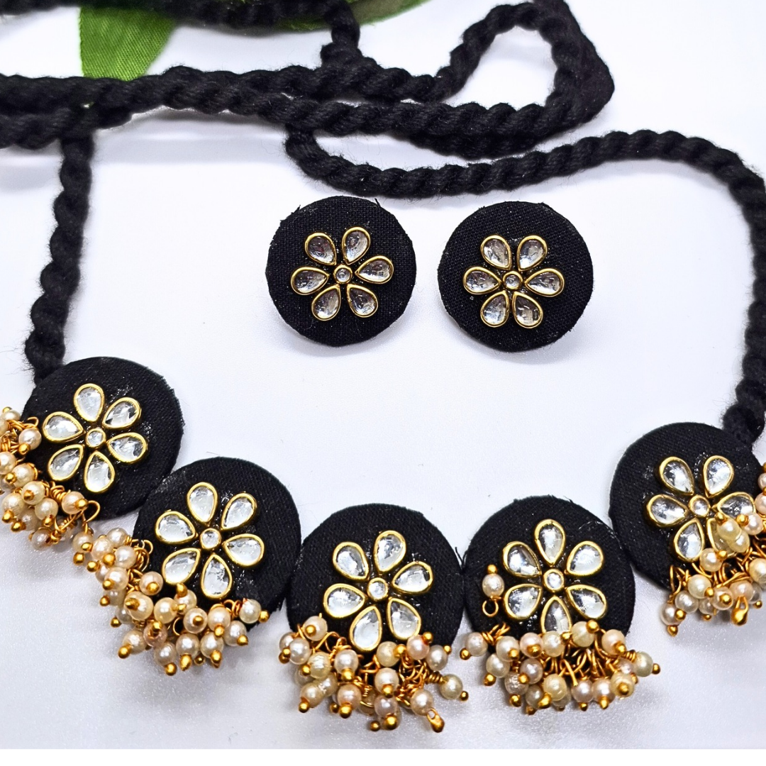 Black fabric jewelry set with floral crystal accents and pearl bead details