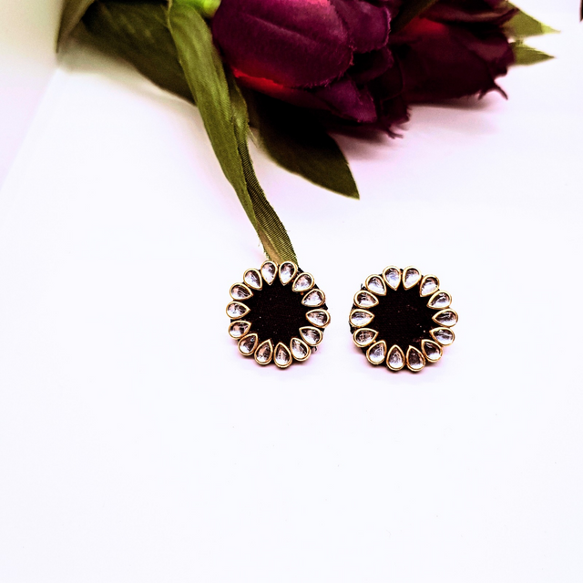 Round gold and black stud earrings with clear teardrop crystals, floral design, on white background
