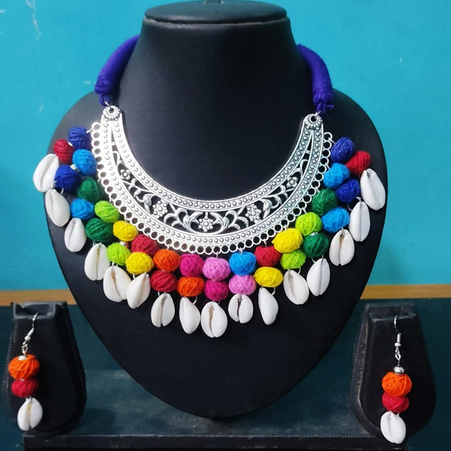 Handcrafted multicolor bead and shell necklace set with matching earrings on display bust